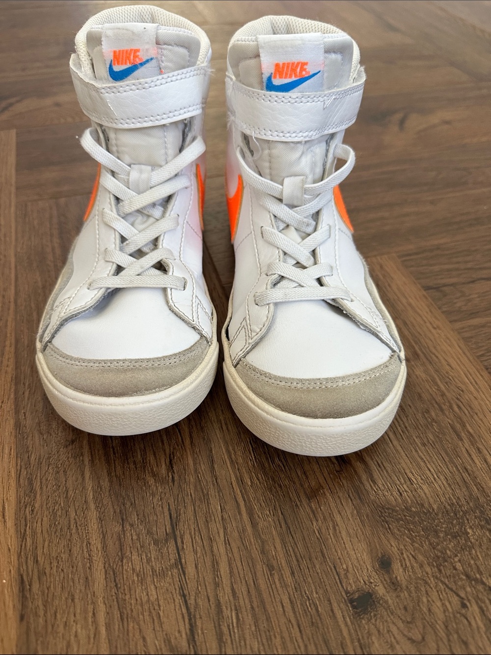 Nike Kids High-Top Sneakers in White with Orange Swoosh